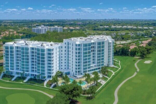 A large white building with trees in the background