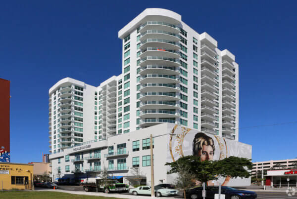 A large white building with many windows and balconies.